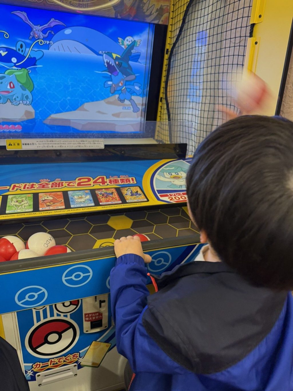 館内のゲームセンターで遊ぶ子どもの後ろ姿